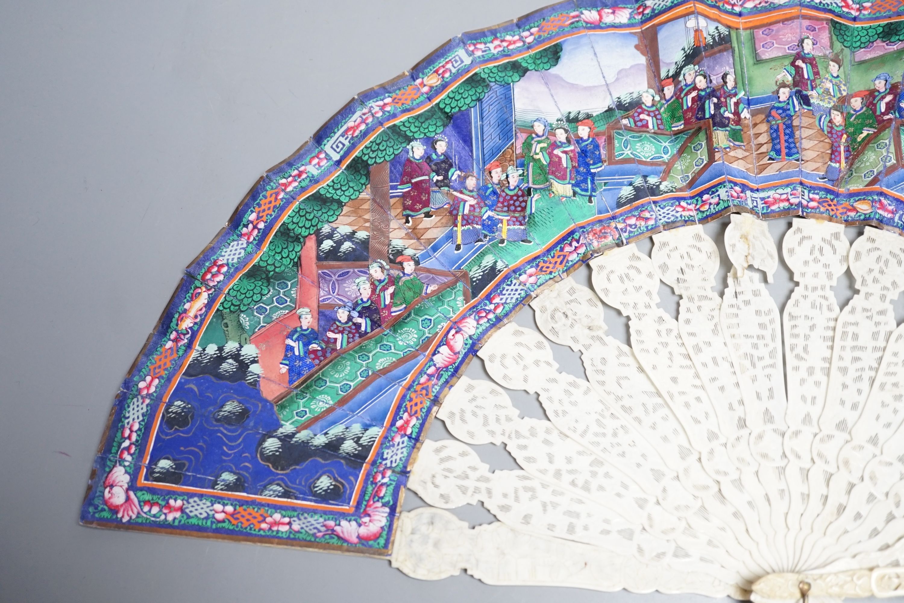 A 19th century Chinese export pierced ivory and painted paper leaf fan, in box. Fan 28cm long